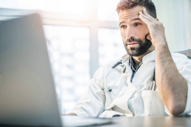 Medical-Coding-Services-a-male doctor reviewing reports for revenue cycle and ready to file complaints with insurances